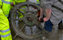 A large ships wheel was exposed by the storms