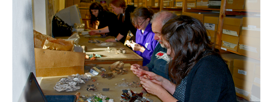 A group of GGAT volunteers of various ages sorting and recording pottery